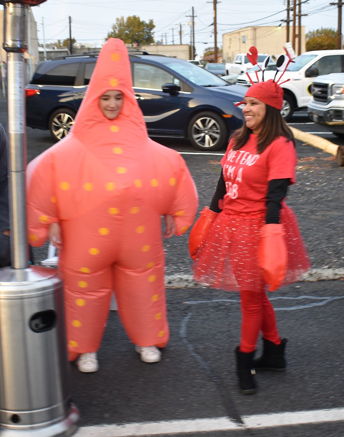 Costumes weren’t just for kids at Ephrata’s downtown trick-or-treat event Thursday. Representing Kids Hope were Celina Garcia, left, and Trisha Glenn.