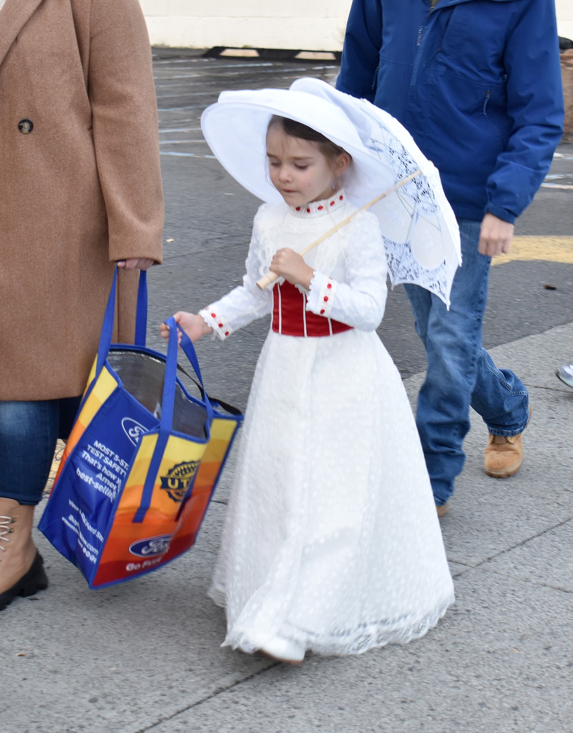 Mary Poppins, who is known as 5-year-old Adelaide Shelley the rest of the year, walks daintily to the next candy stop at Ephrata’s downtown trick-or-treat Thursday.