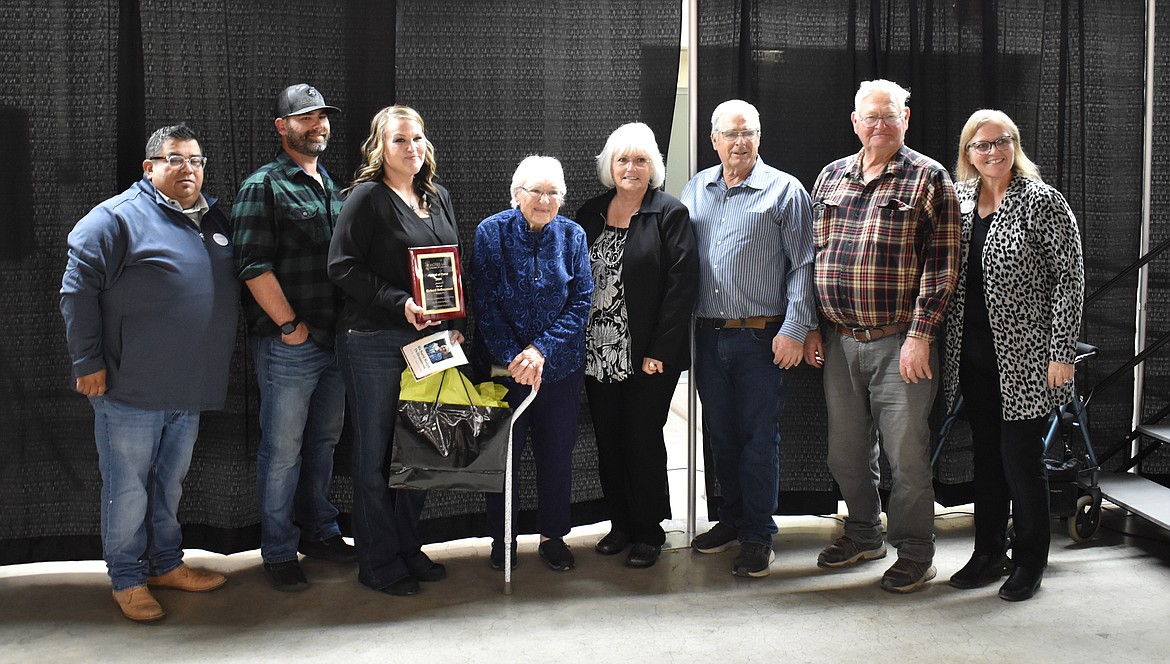 Tara DeBeaumont Zerbo presents her grandmother Mary Eccles DeBeaumont with her late grandfather Richard DeBeaumont’s plaque honoring him as a member of the Moses Lake Agriculture Hall of Fame, flanked by family members and  Moses Lake Chamber of Commerce Board Chair Jason Avila, far left Chamber President and CEO Debbie Doran-Martinez, far right.