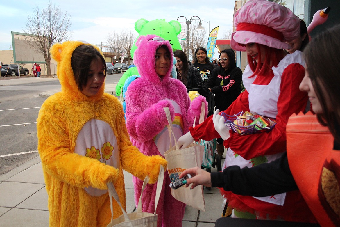 Brightly colored "Care Bears" were collecting candy along the Downtown Trick or Treat route Halloween night in Quincy.