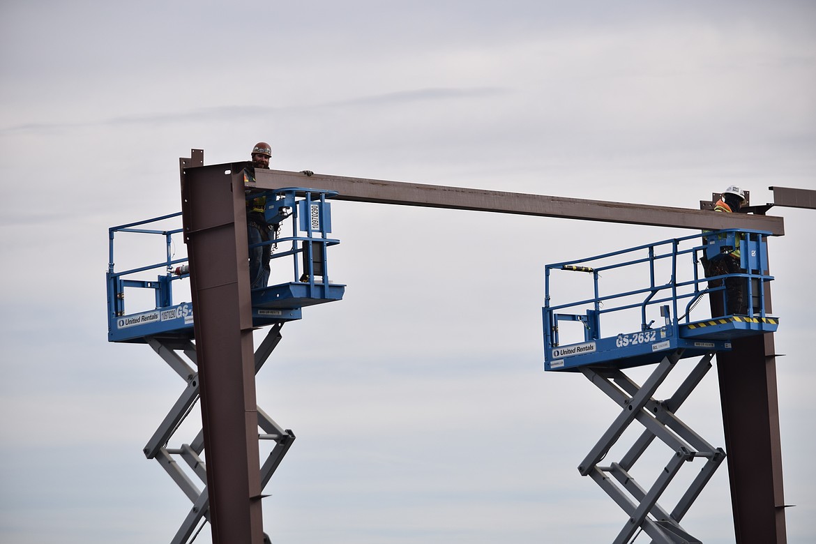 Workers install a girder for the jail building furthest from State Route 17. The buildings will be one story with two layers of cells to house inmates and be physically separated into pods to ensure populations of inmates don’t mix for safety reasons.