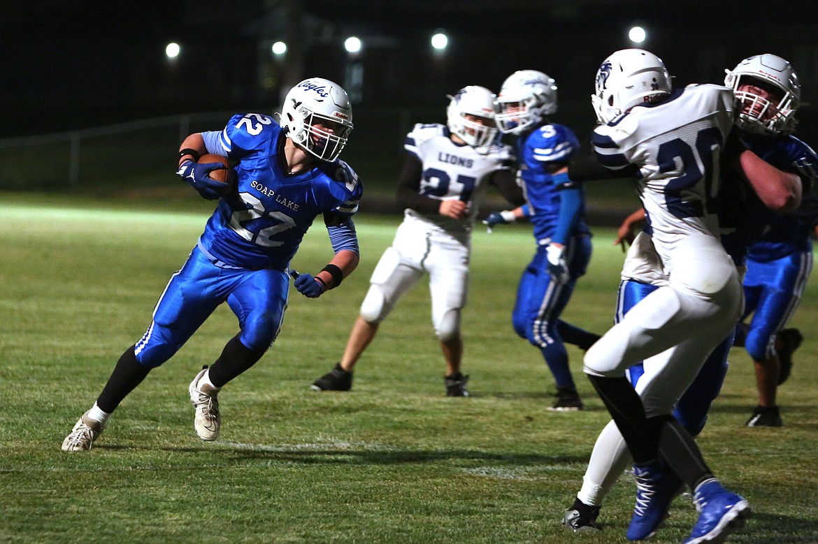 Soap Lake senior Sam Schopf (22) follows his blockers on a run in the first quarter against MLCA/CCS on Friday. Schopf scored two touchdowns in the game.