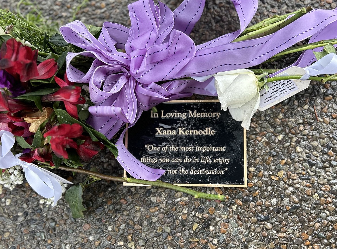 A plaque for Xana Kernodle is decorated with flowers at City Park.