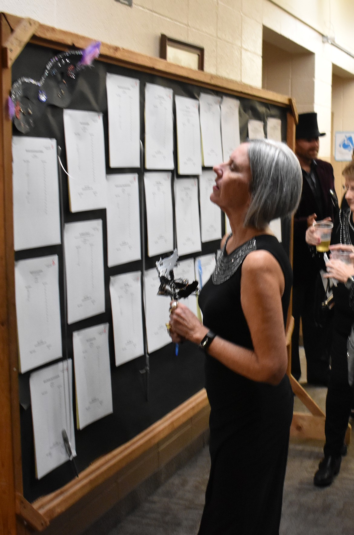 Diane Jenkins of Ephrata looks over the bids on silent auction items at St. Rose of Lima Catholic School’s auction Saturday. The auction raised about $260,000 to help cover the students’ tuition, including scholarships for students in need, Principal Amy Krautscheidt said.