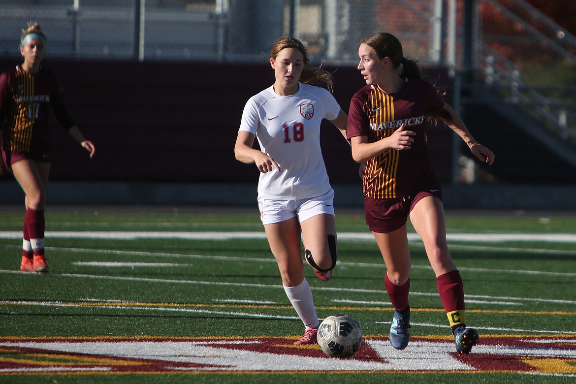 Moses Lake senior Beth Ribellia, right, searches for an open teammate to pass the ball to during the first half against Eastmont on Saturday.