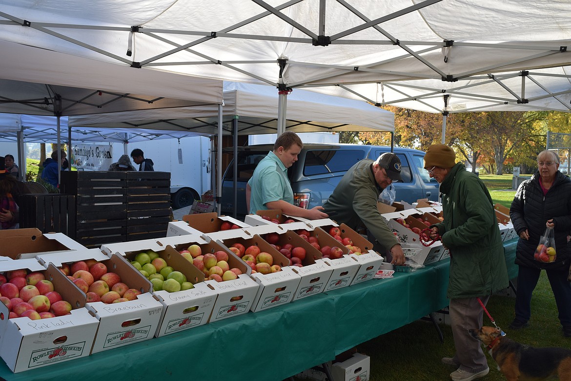 A stand at the Moses Lake Farmers Market was selling apples, veggies and other goods at the final farmers market of the season.