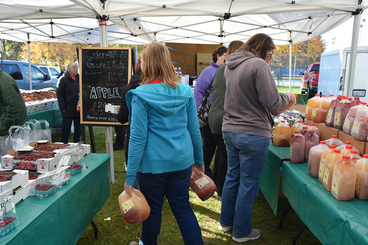 People at the Moses Lake Farmers Market bought gallons of freshly made apple cider.