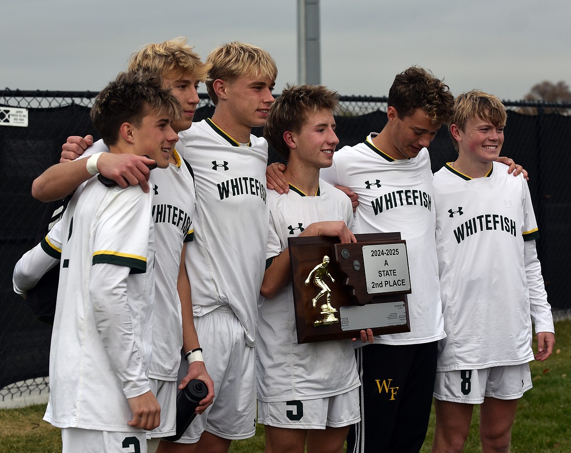 The six seniors on the Whitefish Bulldog soccer team pose with the Class A trophy after the final game on Saturday. (Julie Engler/Whitefish Pilot)