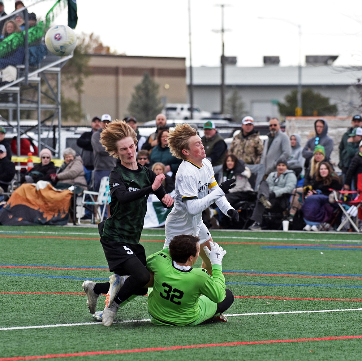 The Billings Central goalkeeper collides with a teammate and Bulldog Griffin Gunlikson. The play resulted in the second penalty kick for Whitefish. (Julie Engler/Whitefish Pilot)