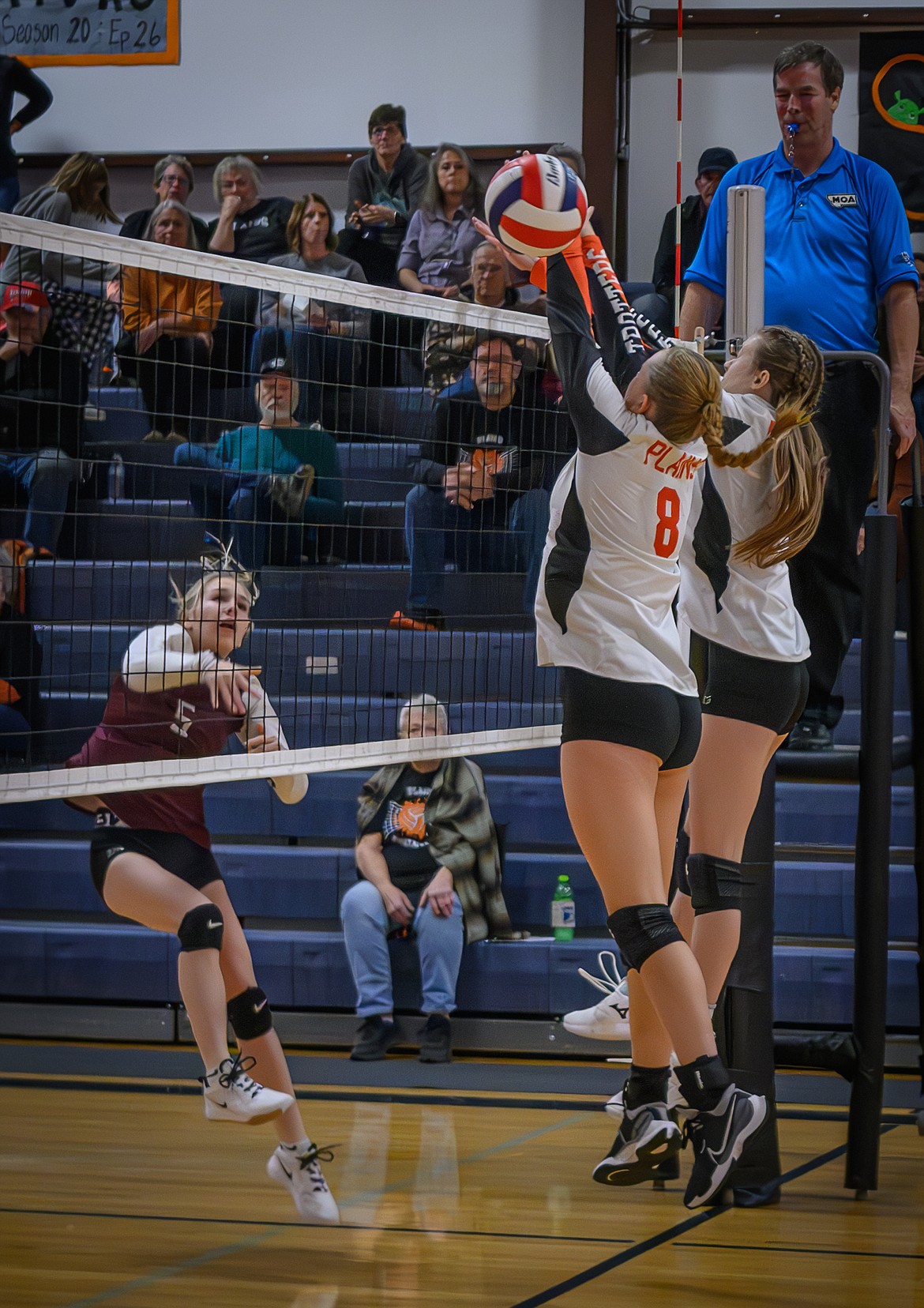 Plains players Teagan Sander (left) and Aubree Butcher go high to block a shot from a Troy player during the two teams' district play-in match last week in Plains.  (Photo by Tracy Scott)