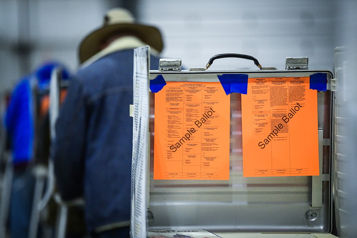 Sample ballots hang inside a voting booth as voters cast their ballots inside the Trade Center at the Flathead County Fairgrounds on Tuesday, Nov. 5. (Casey Kreider/Daily Inter Lake)