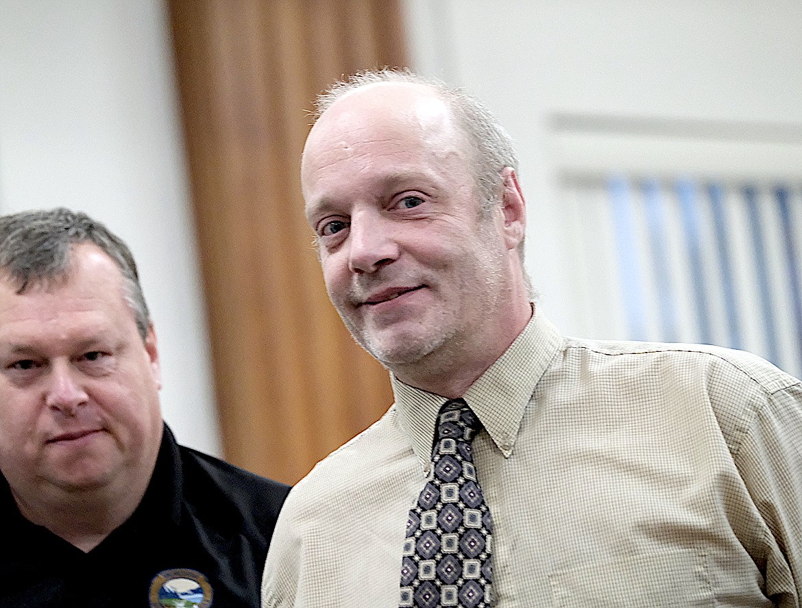 Lincoln County Probation and Parole Officer Steve Watson takes Dan Savage Jr. into custody following his sentencing Monday, Nov. 4, 2024, in the county courthouse. (Scott Shindledecker/The Western News)