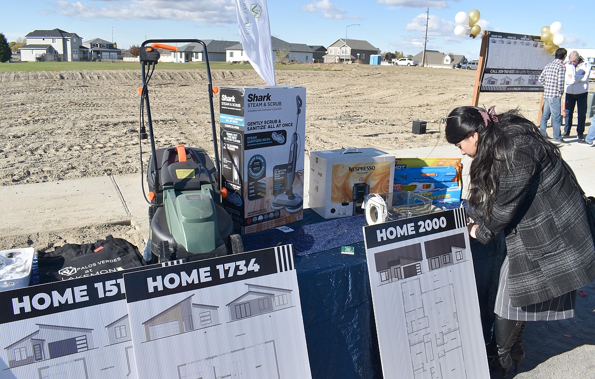 The ribbon-cutting celebration for Palos Verdes at Lakemont in Moses Lake included raffles and a display of floor plans specially designed for the development.