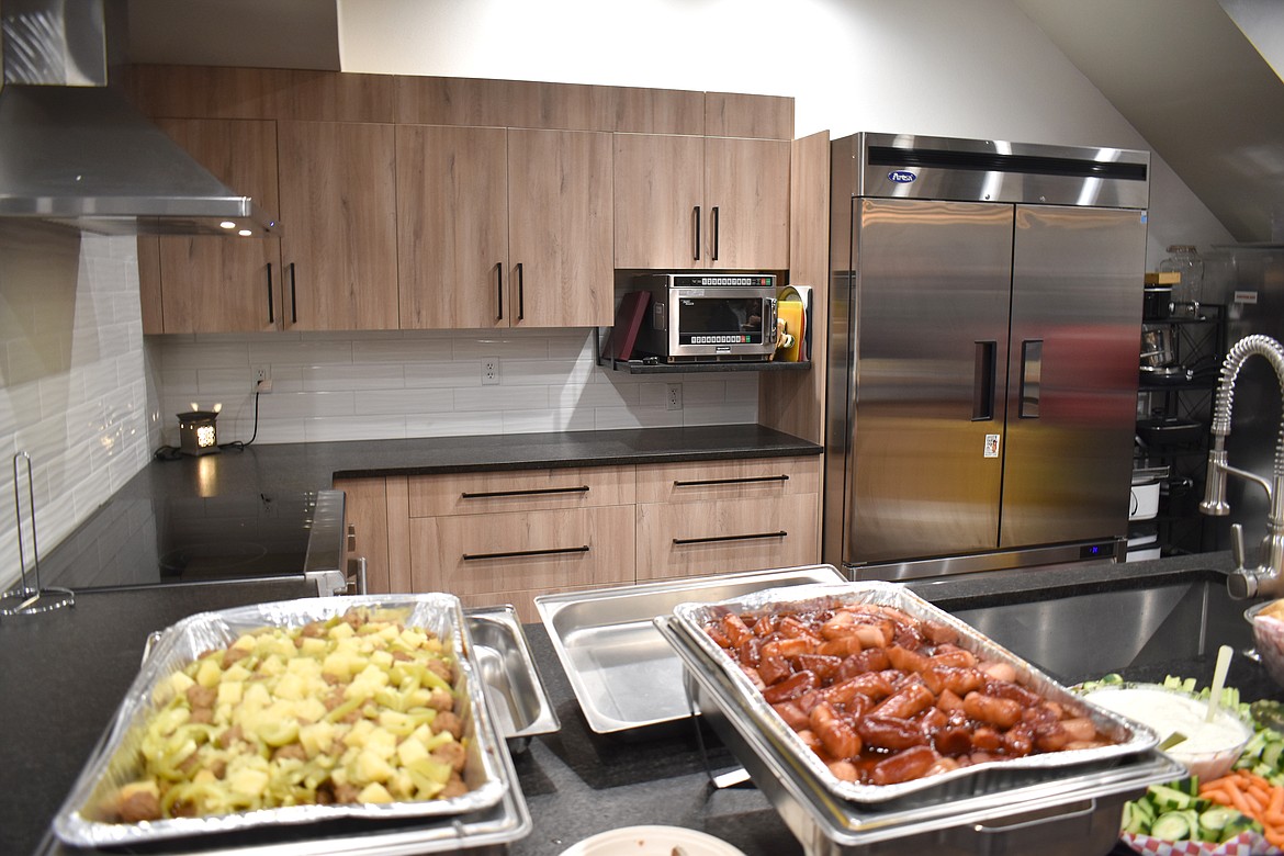 The newly remodeled kitchen at Youth Dynamics is stocked with munchies for the assembled Moses Lake Chamber of Commerce’s Business After Hours Tuesday. Youth Dynamics does more than just meet kids’ spiritual needs, Director Sean Sallis said; it also feeds them and gives them a safe place to hang out and has plans to offer them a place to do laundry as well.