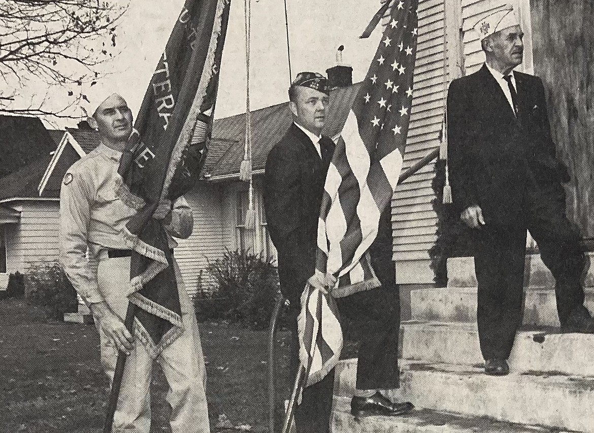 From left, veterans Lee Doolittle, James Shepperd and Ole Myrhang carry the colors into The Church of Truth for a Veterans Day observance in 1964.