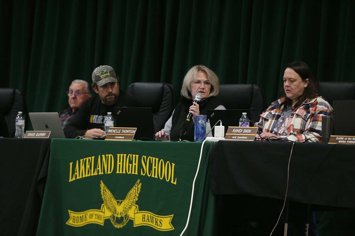 Lakeland School Board Chair Michelle Thompson speaks into the mic Thursday night during a special meeting at Lakeland High School to address the failure of the district's supplemental levy. From left: Trustees Bob Jones and David Quimby, Thompson and Trustee Randi Bain.