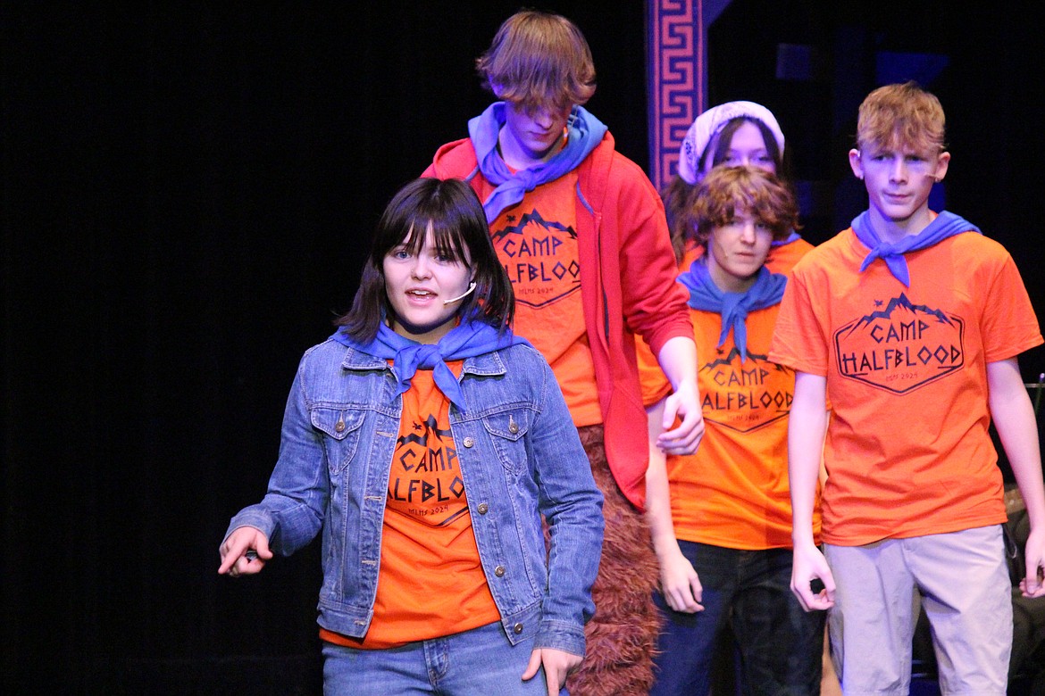 Annabeth (Sophia Villalpando) leads the campers in a song.