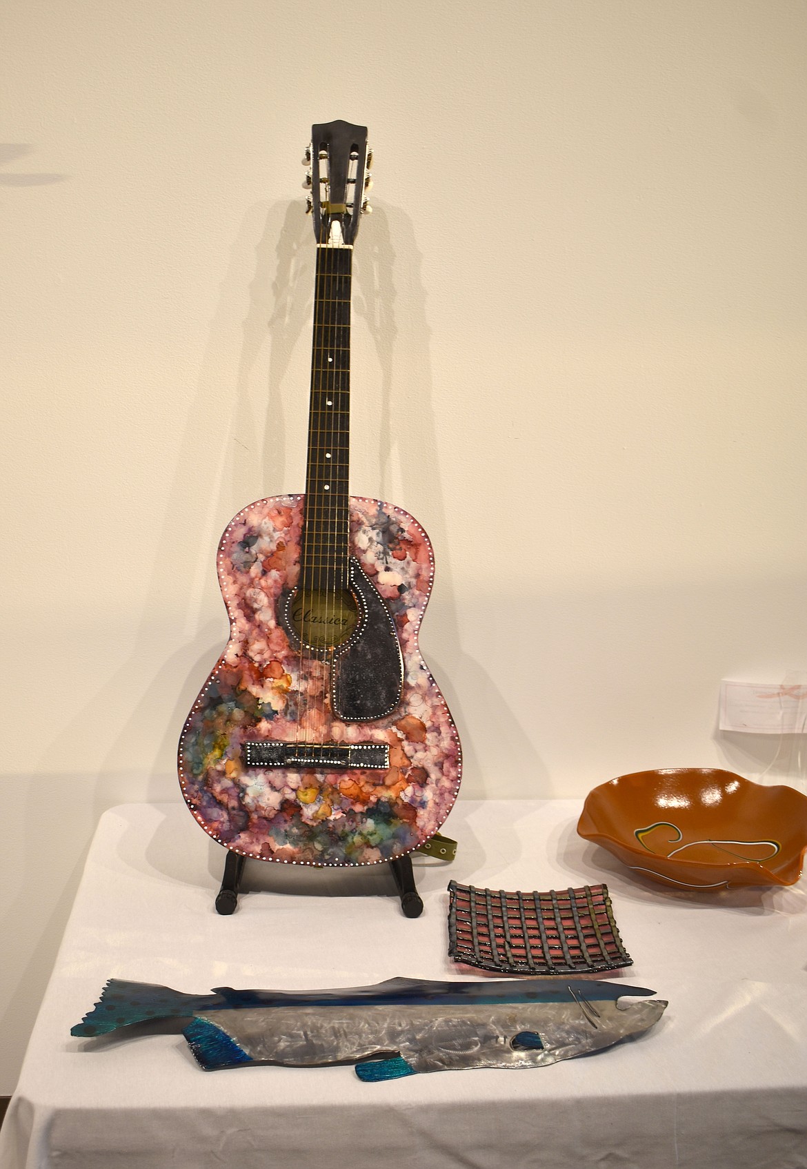 This hand-painted guitar is one of the more unusual pieces in the Moses Lake Museum & Art Center’s members Exhibition, and Museum Director Dollie Boyd’s personal favorite, she wrote in an email to the Columbia Basin Herald.