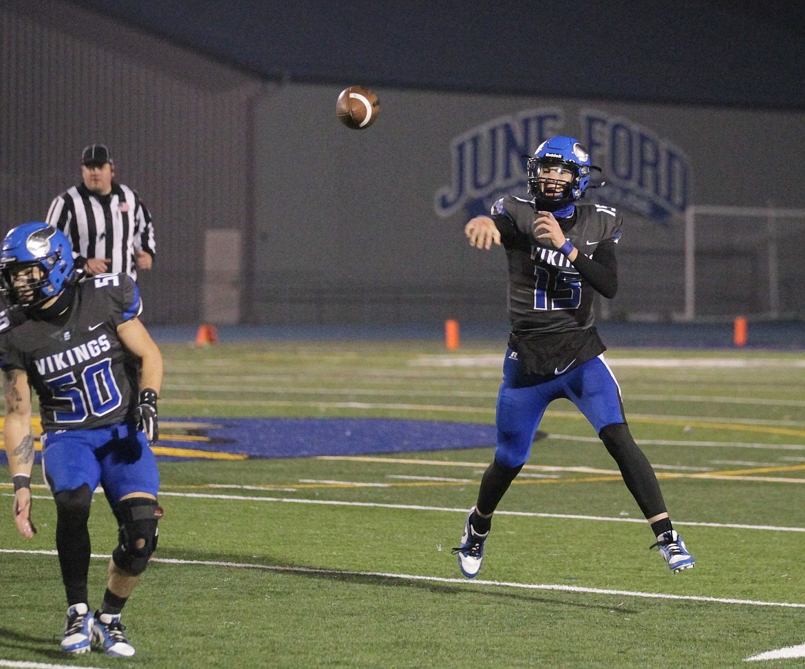 MARK NELKE/Press
Caden Symons (15) of Coeur d'Alene passes as Dylan Memmott (50) protects on Friday night against Middleton at Viking Field. Symons passed for 459 yards in Coeur d'Alene's 35-21 win in a state 6A quarterfinal game.