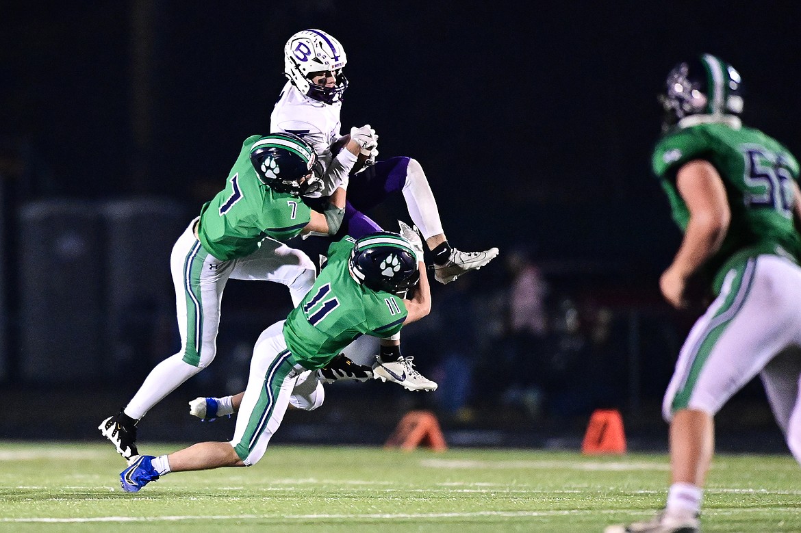 Glacier defenders Grady Robinson (7) and Asher Knopik (11) bring down Butte wide receiver Hudson Luedtke (8) after a reception in the fourth quarter during a Class AA playoff game at Legends Stadium on Friday, Nov. 8. (Casey Kreider/Daily Inter Lake)