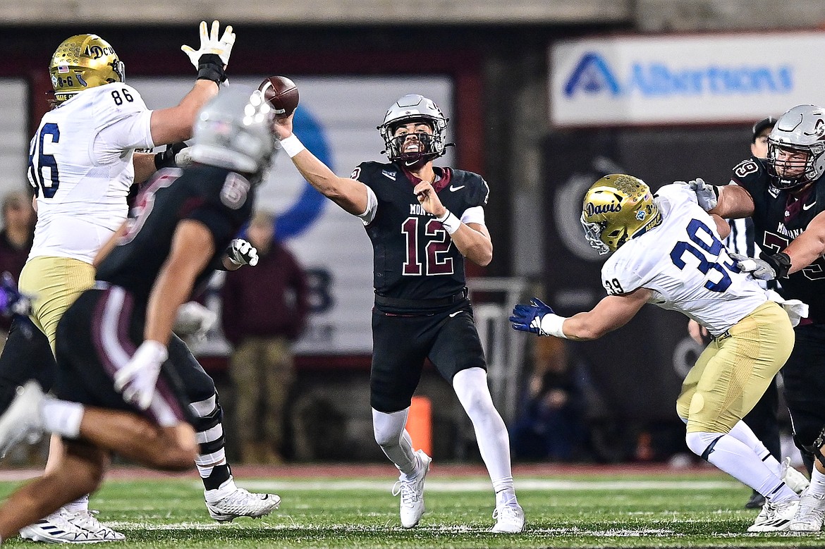 Grizzlies quarterback Logan Fife (12) throws a pass to wide receiver Junior Bergen (5) in the second quarter against UC Davis at Washington-Grizzly Stadium on Saturday, Nov. 9. (Casey Kreider/Daily Inter Lake)