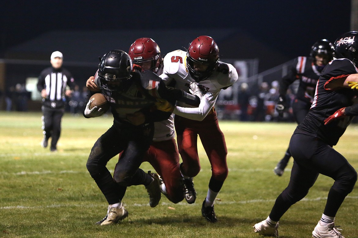 Almira/Coulee-Hartline junior Harvest Parrish, left, rights for extra yards on a 10-yard rushing touchdown in the second quarter against Dayton on Friday. Parrish scored three touchdowns in the win, all of which came in the second quarter.