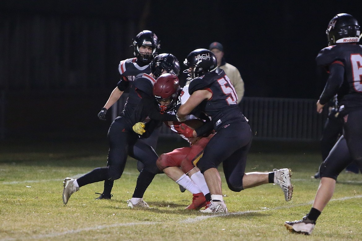 A pair of Almira/Coulee-Hartline defenders tackle a Dayton receiver in the second quarter on Friday night. ACH held the Bulldogs to under 250 yards of total offense in the win.