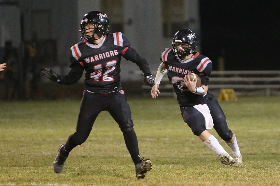 Almira/Coulee-Hartline junior Caden Correia (2) runs with the ball while Warrior junior Luke Goetz (42) blocks on a run play in the fourth quarter against Dayton.