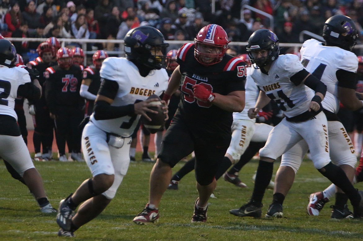 Othello senior Mason Perez (50) breaks through the Pirate offensive line to pressure the quarterback. Perez recovered a fumble in the fourth quarter.