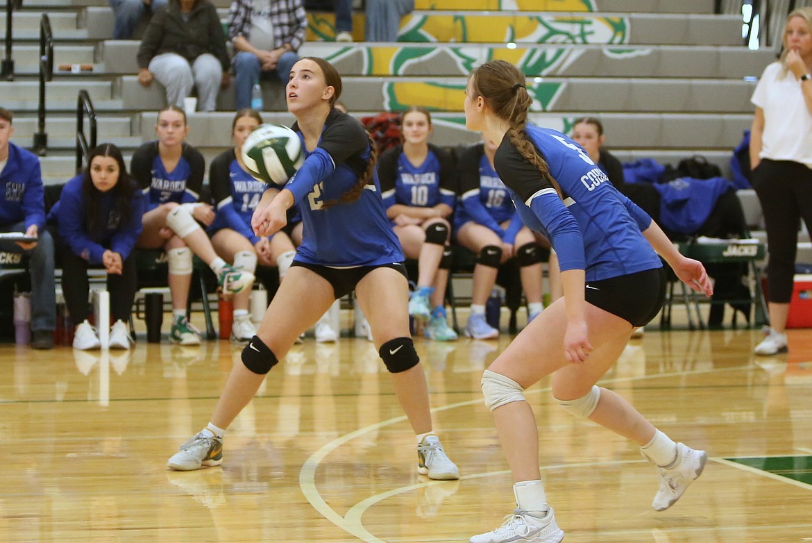 Warden junior Amaya Erickson, left, receives a serve during the third set against Kittitas on Saturday morning.