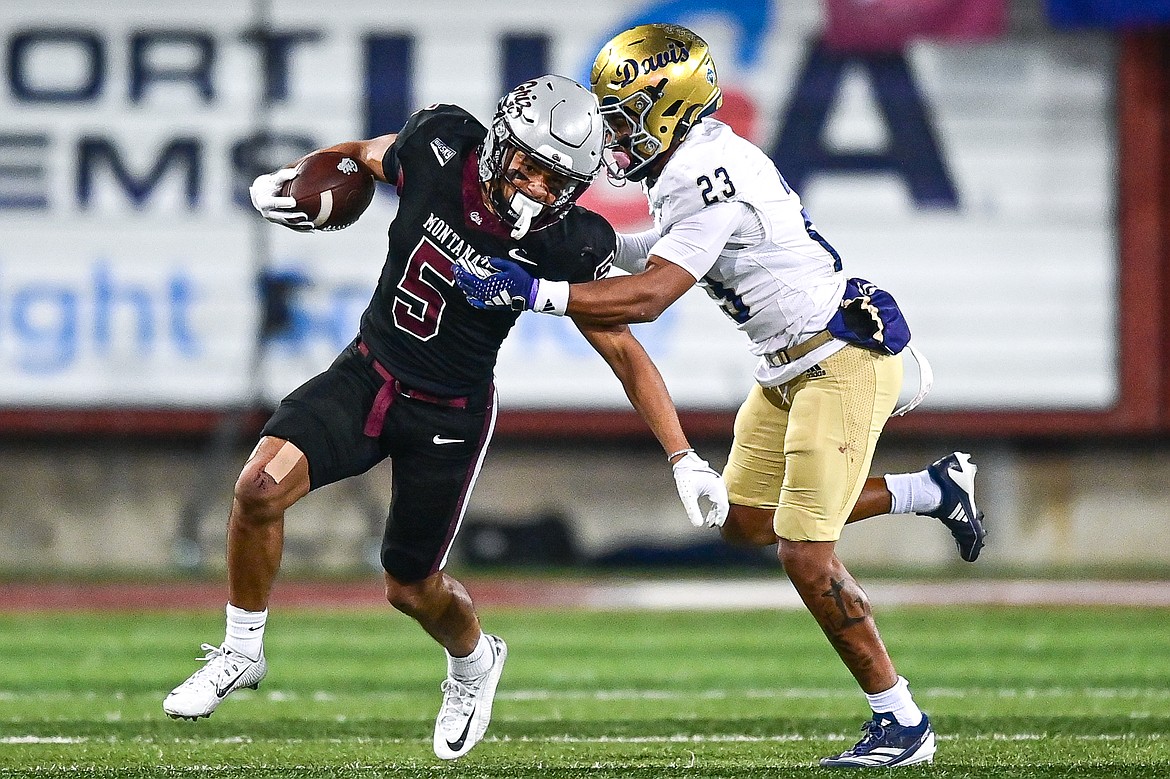 Grizzlies wide receiver Junior Bergen (5) looks for running room with UC Davis defensive back Kavir Bains (23) in pursuit in the second quarter at Washington-Grizzly Stadium on Saturday, Nov. 9. (Casey Kreider/Daily Inter Lake)