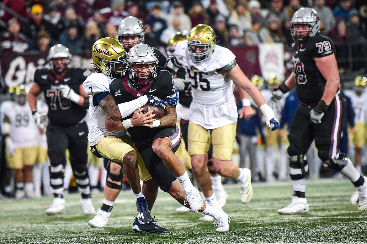 Grizzlies quarterback Keali'i Ah Yat (8) breaks a tackle on an 18-yard run to the goal line in the third quarter against UC Davis at Washington-Grizzly Stadium on Saturday, Nov. 9. (Casey Kreider/Daily Inter Lake)