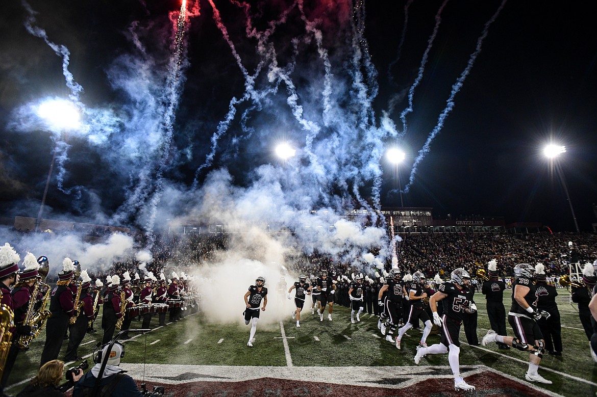 Smoke and fireworks hang in the sky as the Montana Grizzlies take the field before their matchup with UC Davis at Washington-Grizzly Stadium on Saturday, Nov. 9. (Casey Kreider/Daily Inter Lake)