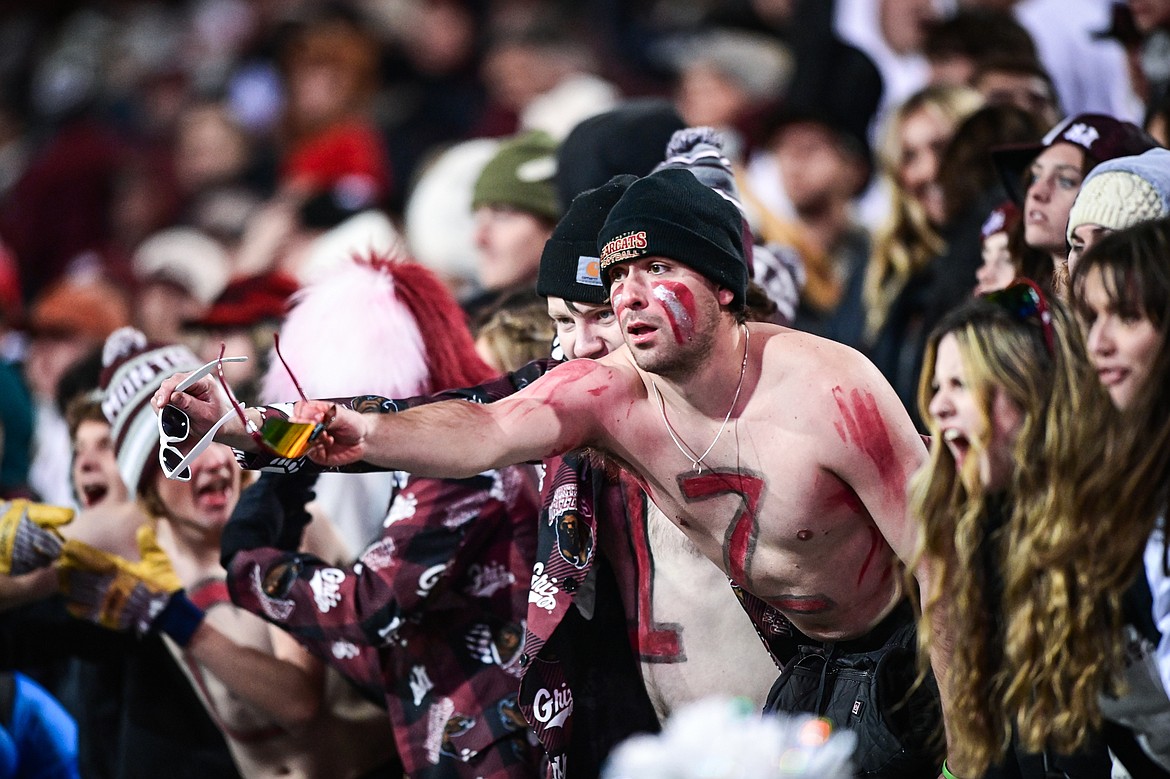 Fans in the student section offer a referee their sunglasses after a touchdown call on a run by Grizzlies quarterback Keali'i Ah Yat (8) was reversed in the third quarter against UC Davis at Washington-Grizzly Stadium on Saturday, Nov. 9. (Casey Kreider/Daily Inter Lake)