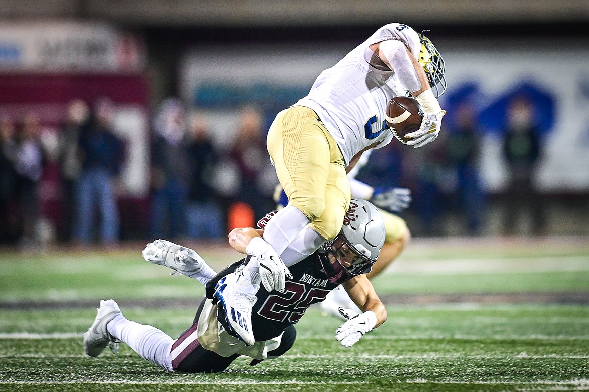 Grizzlies safety Jaxon Lee (25) tackles UC Davis running back Lan Larison (3) in the first quarter at Washignton-Grizzly Stadium on Saturday, Nov. 9. (Casey Kreider/Daily Inter Lake)