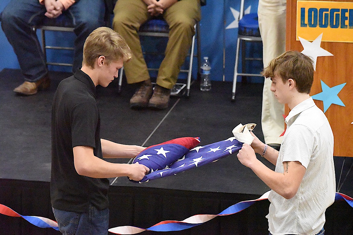 Libby High School students Tristan Andersen and Urijah Bache perform a U.S. flag folding Monday, Nov. 11, 2024, during a Veterans Day Assembly at Libby High School. (Scott Shindledecker/The Western News)