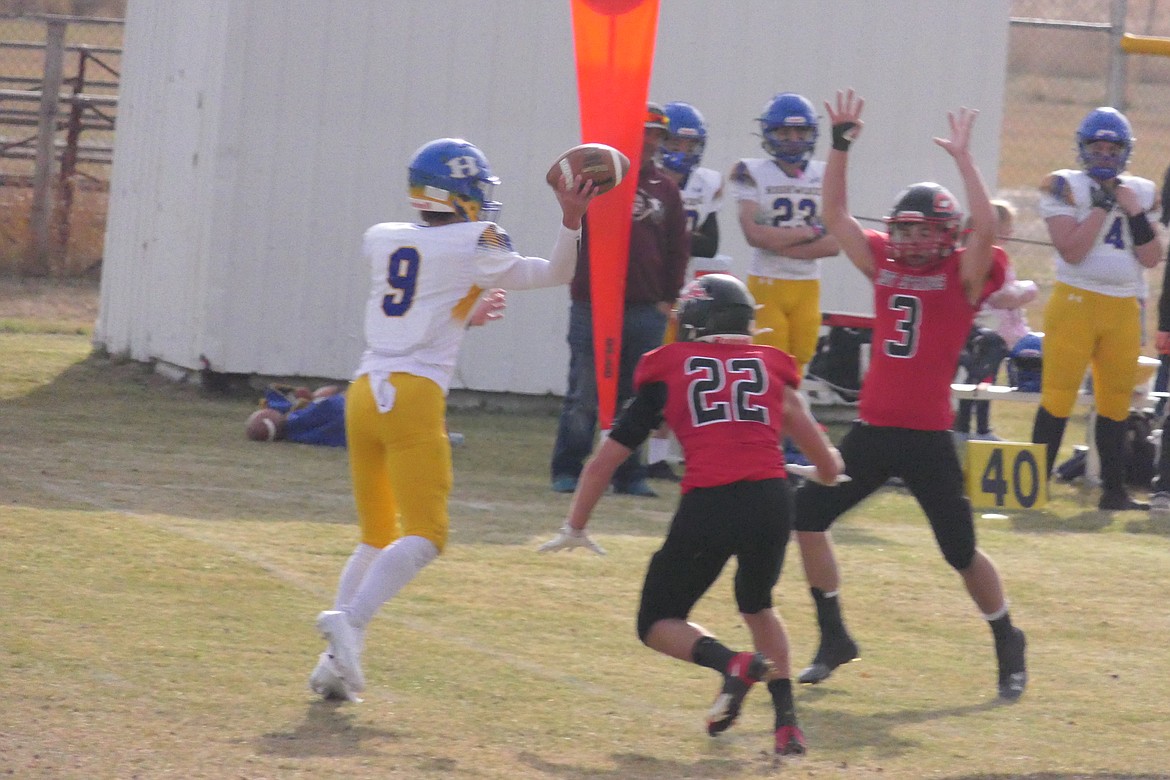 Highwood quarterback Chase Tinklenberg (9) tries to get off a pass while being pressured by the Slonaker brothers, Weston (22) and Daniel (3) during their game Saturday in Hot Springs.  (Chuck Bandel/VP-MI)