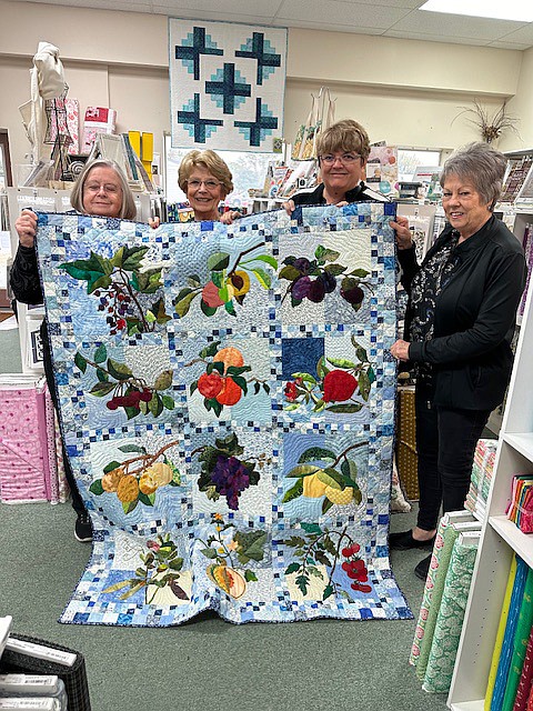 Items for the Fabric Patch cancer fundraiser were donated from all over, including this quilt from the Yakima Applique Quilt Guild that sold for $2,025.