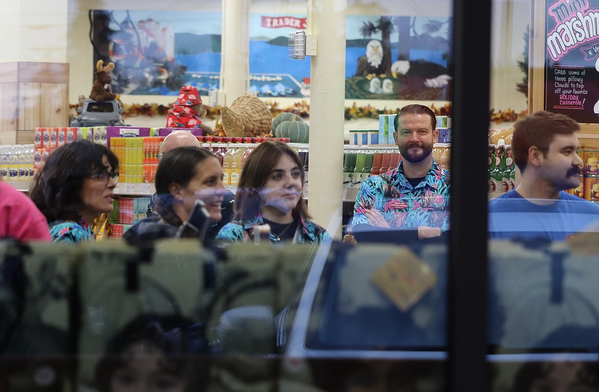 Trader Joe's employees look out the window before the opening of the Coeur d'Alene store Tuesday.