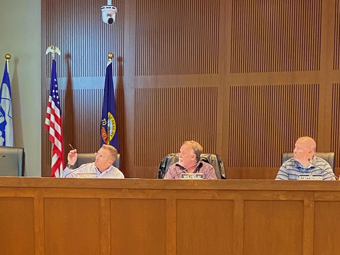 Commissioner Chris Schreiber asks a question during a planning and zoning commission meeting for Post Falls Tuesday as Commissioners Bobby Wilhelm and James Steffensen watch.