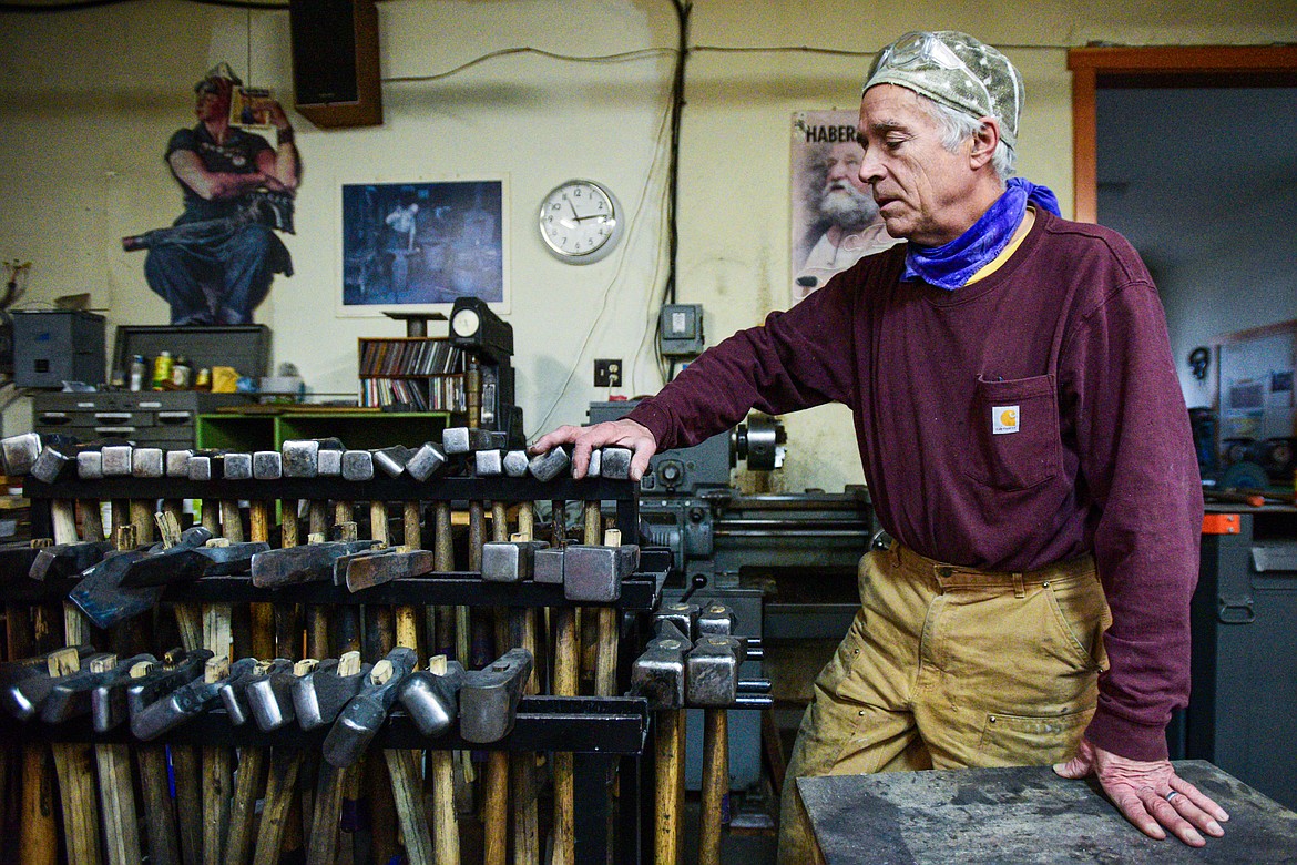 Jeffrey Funk describes a variety of blacksmithing hammers and tools inside his workshop at the New Agrarian School in Bigfork on Tuesday, Nov. 12. (Casey Kreider/Daily Inter Lake)