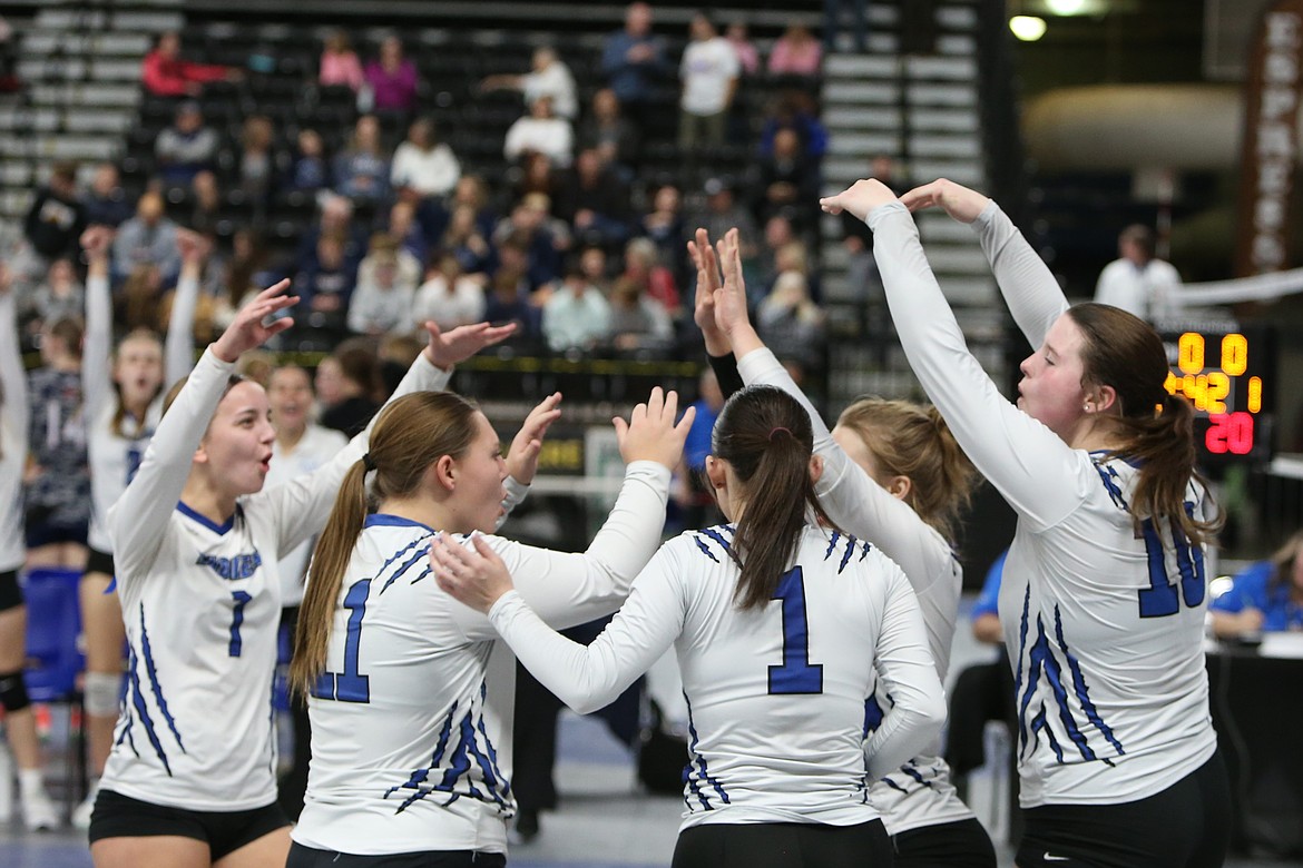 Eagle players celebrate after blocking a spiked ball during Wednesday’s match against Pe Ell in Yakima.