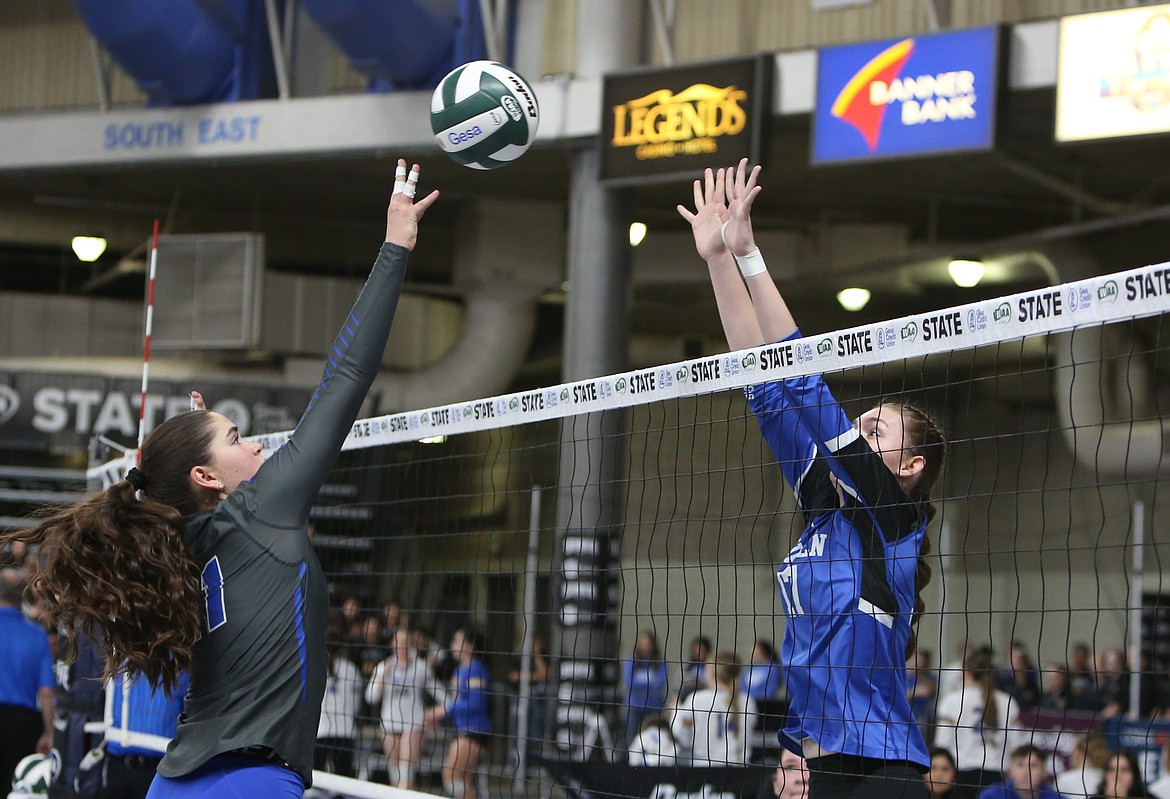 Warden sophomore Hannah Roylance, right, leaps up to block a spike against Manson in the first round of the 2B State Volleyball Tournament.