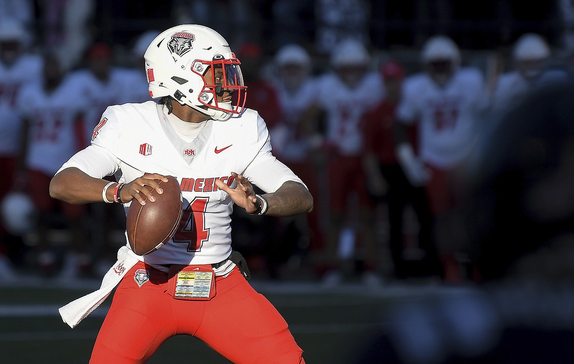 New Mexico quarterback Devon Dampier drops back to pass during a game against Utah State on Oct. 19. Dampier leads the Lobos in rushing, with 872 yards and 13 touchdowns.