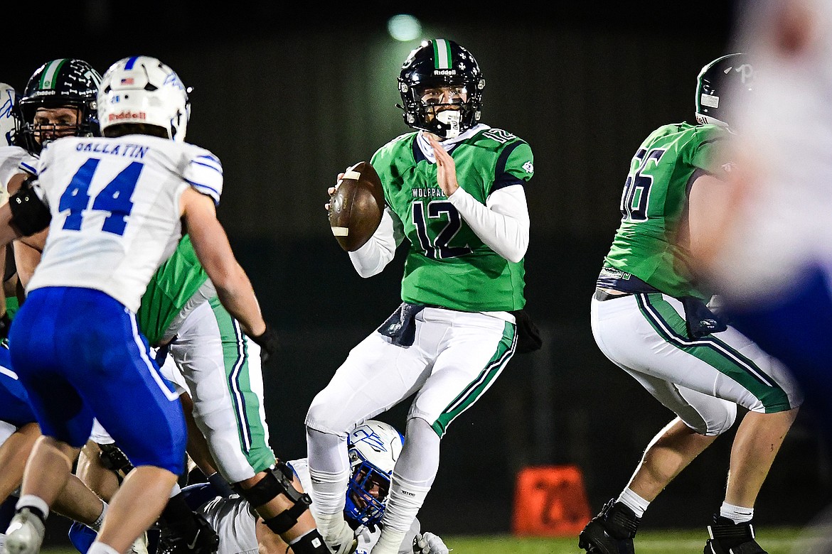 Glacier quarterback Jackson Presley (12) drops back to pass in the third quarter against Gallatin in the Class AA semifinals at Legends Stadium on Friday, Nov. 10. (Casey Kreider/Daily Inter Lake)