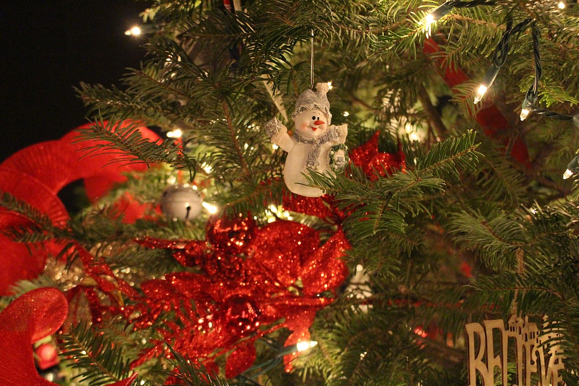 A snowman waves from one of the trees at a previous Festival of Trees.