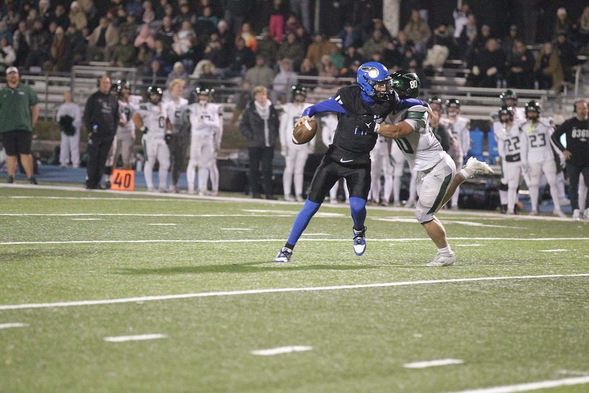 JASON ELLIOTT/Press
Coeur d'Alene quarterback Caden Symons attempts to throw the ball as Eagle's Nate Williams applies pressure during Friday's state 6A football semifinal game at Viking Field.