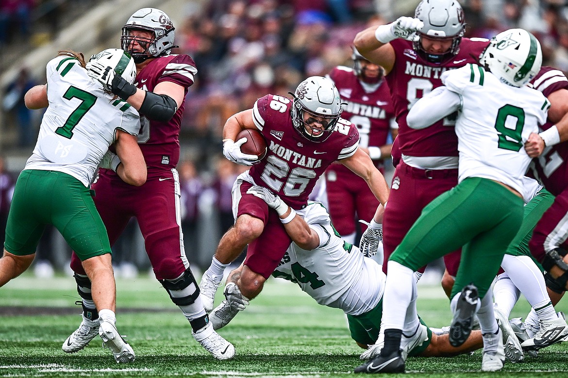 Grizzlies running back Nick Ostmo (26) sheds a tackle in the backfield on a 10-yard run in the second quarter against Portland State at Washington-Grizzly Stadium on Saturday, Nov. 16. (Casey Kreider/Daily Inter Lake)