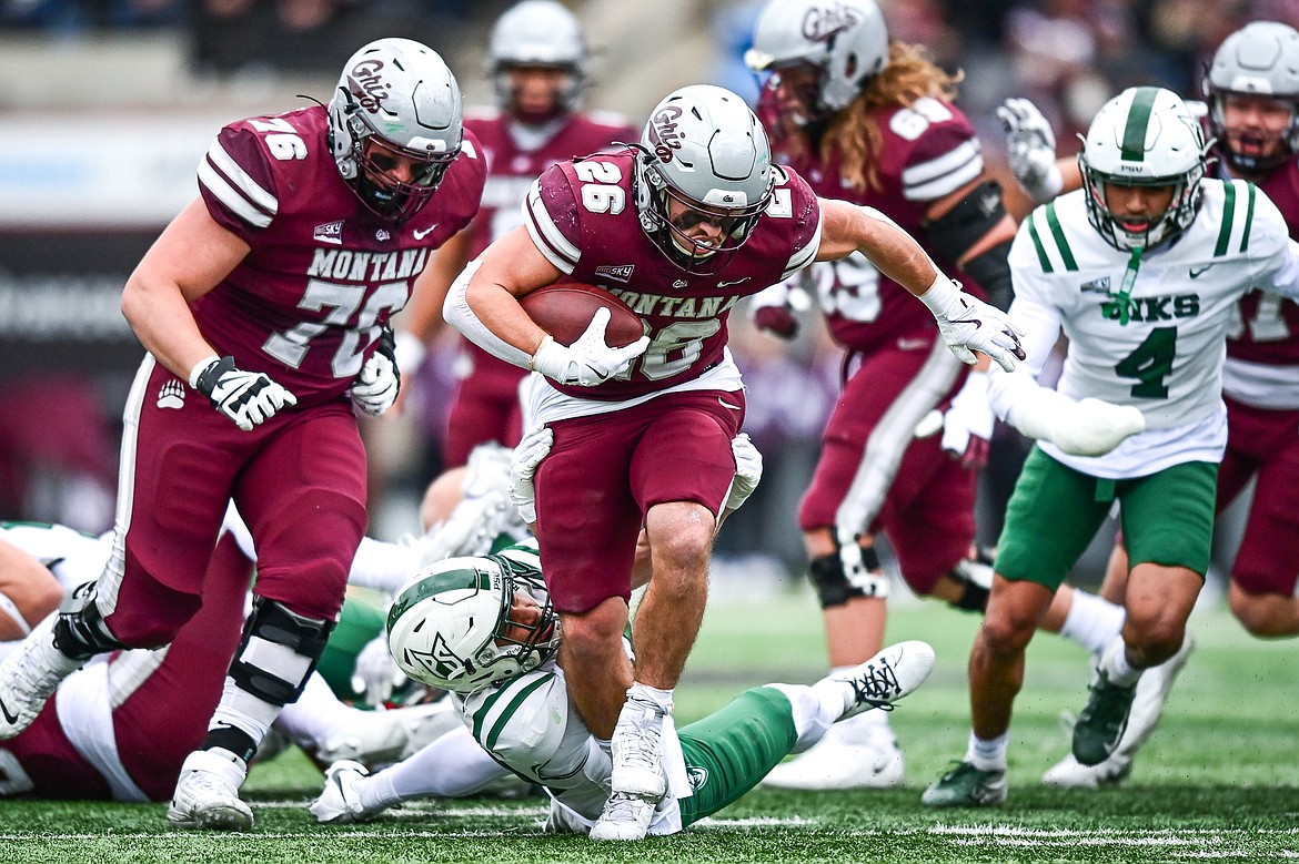 Grizzlies running back Nick Ostmo (26) sheds a tackle in the backfield on a 10-yard run in the second quarter against Portland State at Washington-Grizzly Stadium on Saturday, Nov. 16. (Casey Kreider/Daily Inter Lake)