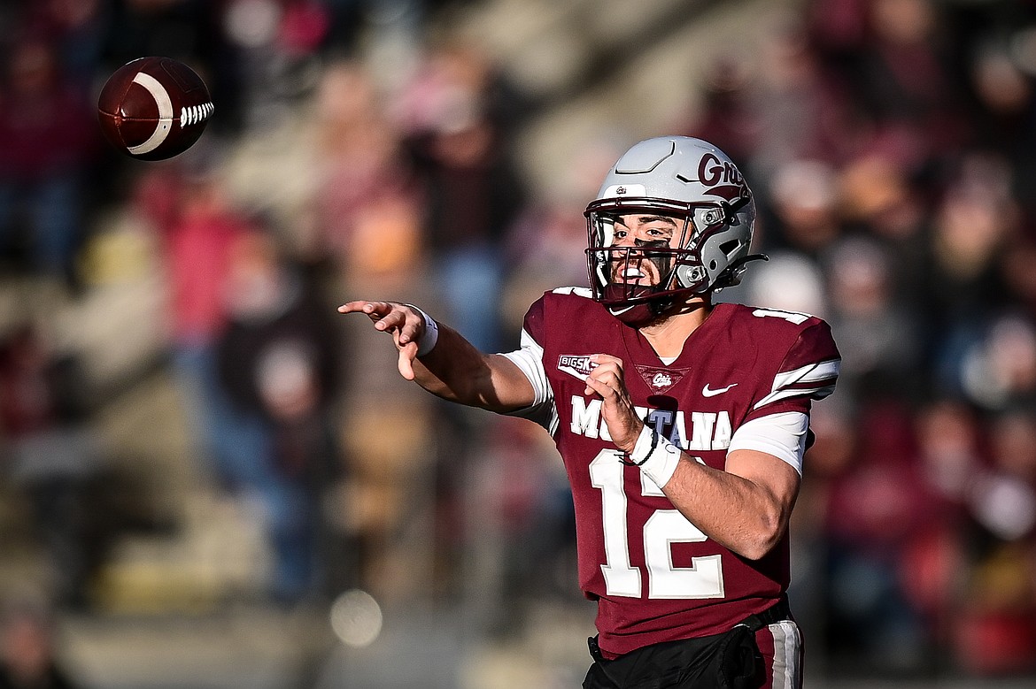 Grizzlies quarterback Logan Fife (12) completes an 11-yard pass to running back Nick Ostmo in the third quarter against Portland State at Washington-Grizzly Stadium on Saturday, Nov. 16. (Casey Kreider/Daily Inter Lake)